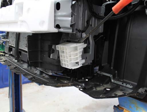 Using a pry bar, remove the plastic insert on the driver s side of the vehicle.