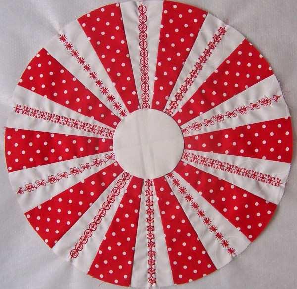 Using the appliqué method of your choice, prepare a white 3 circle for appliqué. Fold the circle in half vertically and horizontally, and finger press to crease.