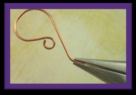 Step 19 Use chain-nose pliers to gently turn up the straight end of the wire, creating a tail that