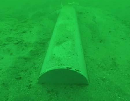 Figure 15. An underwater photograph of a 10 cm x 50 cm cylinder deployed in the WHOI REMUS 600 test site off Shell Island, FL.