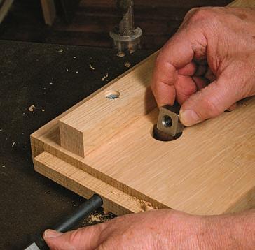 With the stub tenons fitted and the cleats attached, clamp the bed together with long pipe clamps. Then fit a 3 8-in. drill bit through the 3 8-in.