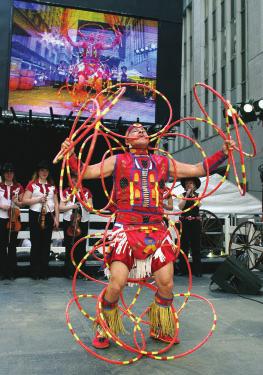 . Takoda and his sister Talula are hoop dancers. In part of a dance, the spin hoops about their arms.