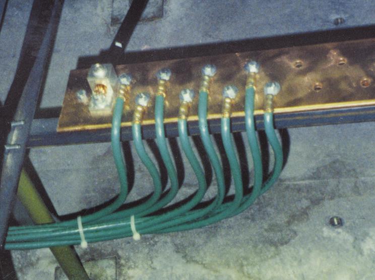 FIGURE 9A. FIGURE 9B. Modifications to the sub-floor grid: (a) Grounding jumpers (#6-4/0 AWG green cables) connect copper ground buses in nearby equipment cabinets to a 6-in X 1/4-in (150-mm X 6.