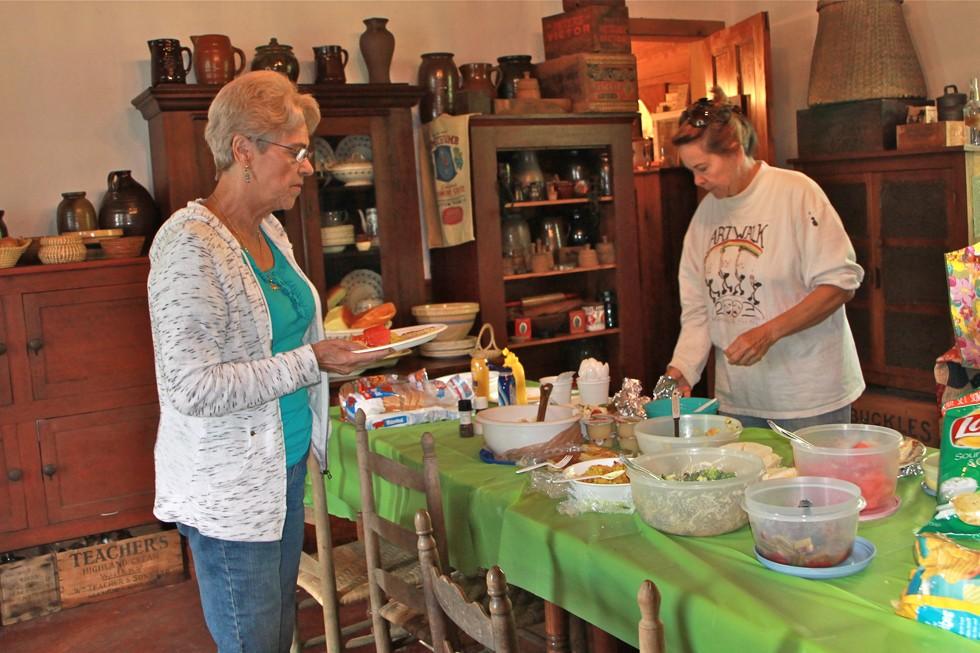 Left: Isabelle Moure and Carol Veliotis prepare the usual gourmet picnic lunch provided by our guild artists.