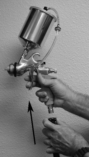 Locate the adjustment marks on the side of the spray gun body. Turn the fan control ring up to achieve a smaller fan or down to achieve a larger fan. 3.