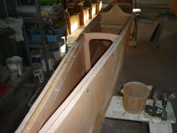 Plywood will bend in a fair curve but laminated foam is too stiff to bend.