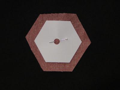 Be sure to punch a hole in your hexagon paper before you begin stitching. Pin the paper to your fabric and cut a generous 1/4 inch seam allowance.