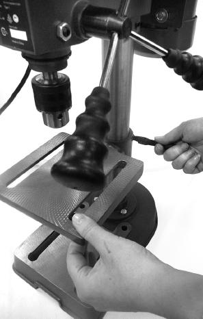 Set the desired table height and tighten the table support lock (23) to secure the table (11) in position (Fig. 15).