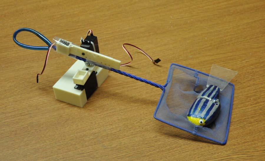 Figure 2 Servos in housing with base, arm, and net attached. Arm fabrication The robotic arm was created in SolidWorks, (see Figure 3), with two degrees of freedom.