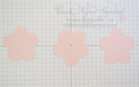 Mark a center point lightly in pencil on each of the three flowers. Cut from the outer edge of the flower to the center on flower number one as shown.