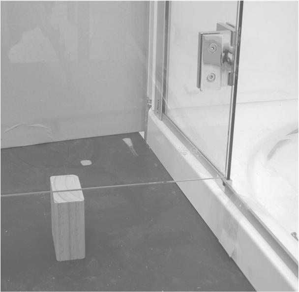 From inside the shower adjust the gap between the Door and Take-up glass by loosening each hinge on the door side one at a time and insert the alignment gauge as a guide.
