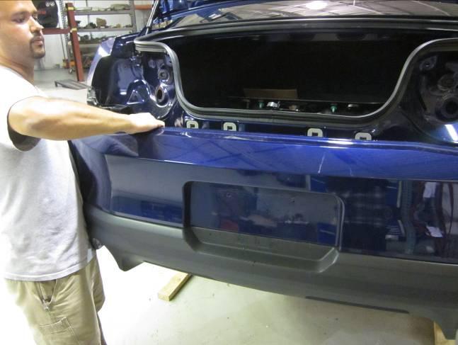 quarter panels during removal process. With free hands, pull fascia swiftly rearward to dislodge 4 remaining fasteners.