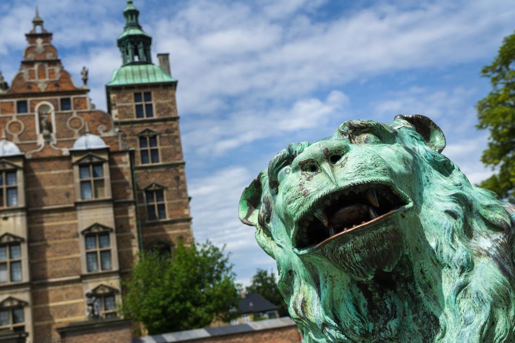 Standing Guard - Rosenborg Palace - Copenhagen, Denmark I changed my point of view to frame this interesting lion statue in the open sky next to the castle.