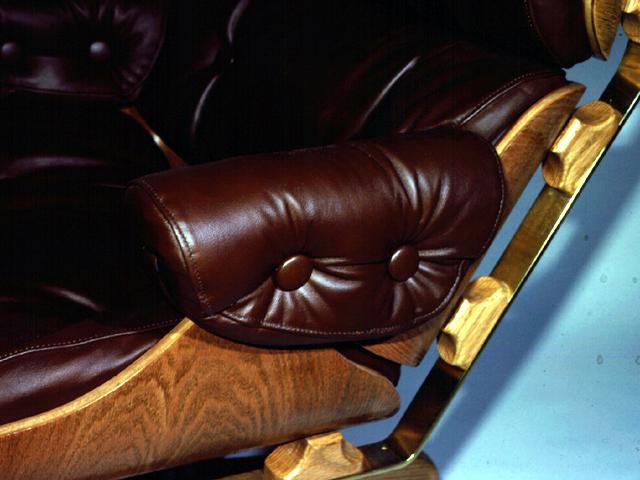 Beneath the arm upholstery, the joining of the two plywood shells