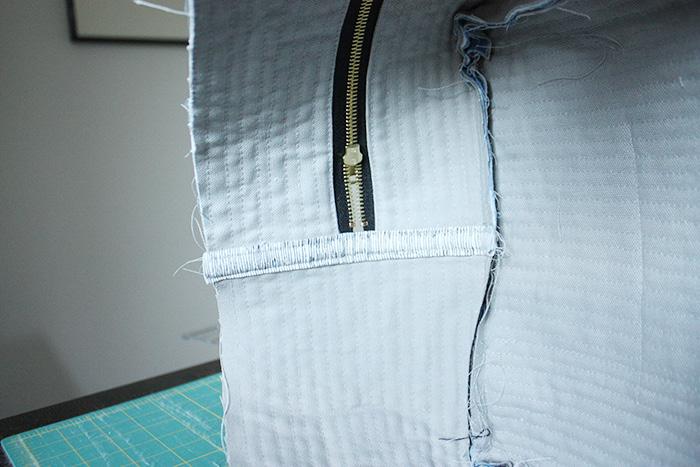 side facing down). Sew along edge of zipper using a 1/4 seam allowance.