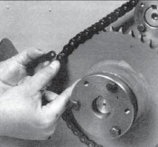 Find the master link of the chain by locating the clip used to hold the master link in place. This clip will be on the side of the chain farthest from the machine (Photo #4). 10.