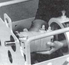 should face toward the back of the machine. 15. Screw the spanner nut onto the end of the shaft. The bevel on the nut should be toward the front of the machine. 16.