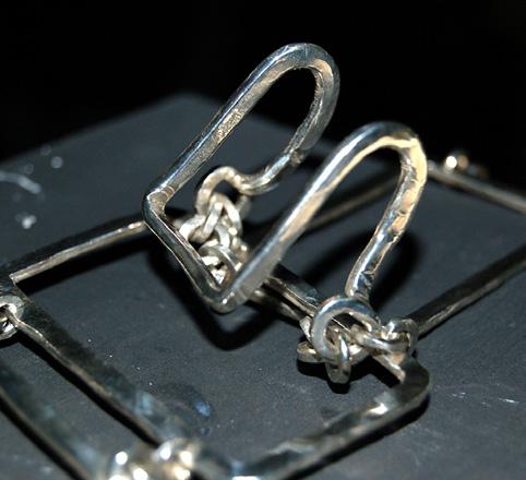 Solder the C-shaped jump rings in place with hard solder. [10] Make larger jump rings, and assemble the chains. Wrap 8 ft. (2.44m) of 14-gauge (1.6mm) sterling silver wire around a 5mm ( 3 16-in.
