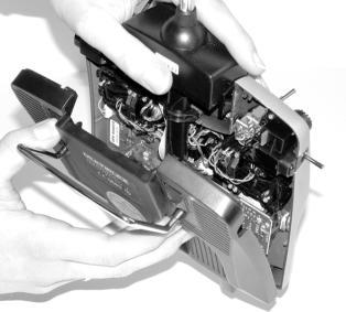 Hold the transmitter in both hands, and push the rear-mounted sliding latches down with both thumbs (towards OPEN ) ( Fig. 9.4.1.1.). b. Carefully remove the rear case panel ( Fig.