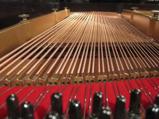 A newly installed set of bass strings in a 125-year-old Weber grand gives the piano a rich bass sound once again. "In business to bring your piano to its full potential.