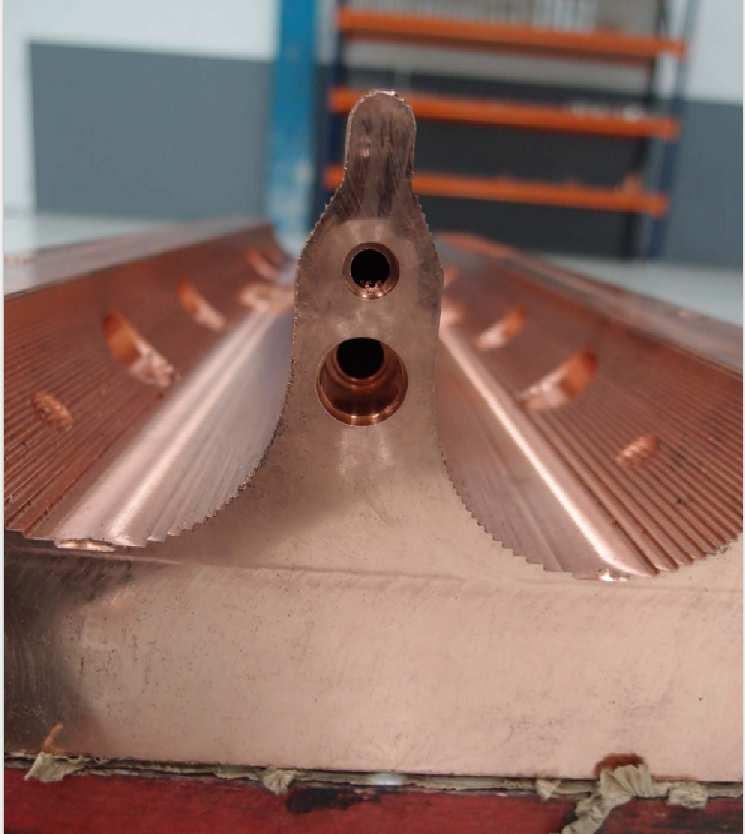 1 FIG. 19. A major vane after rough machining. The holes of the cooling channels can be seen in the vane. and no external evidence of the welding of the plugs will be visible. 4.