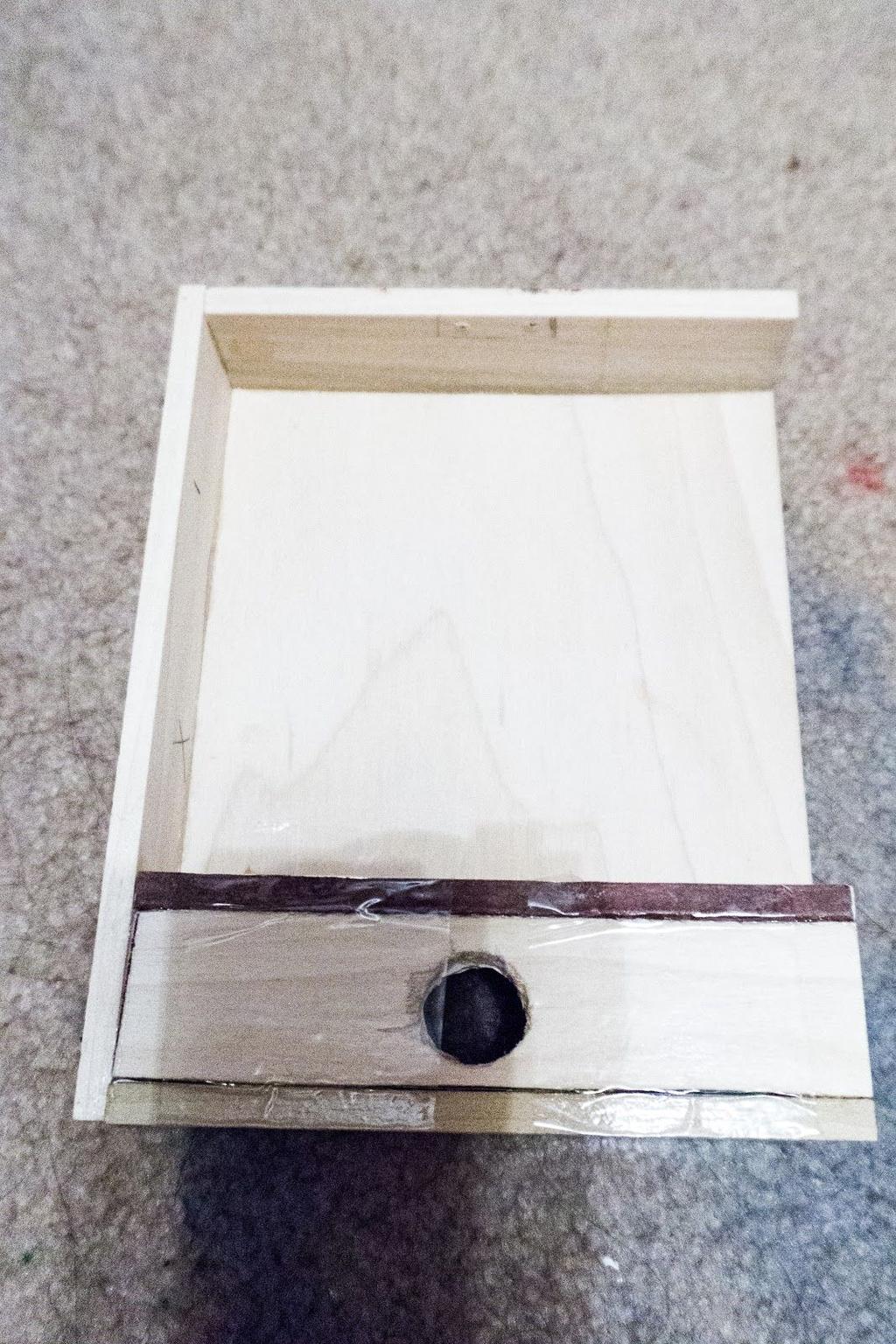 Use the E6000 glue to attach (3) short wall wood pieces, (1) long wall piece, the wood piece with the lock, and the 5.25 inches x 1.
