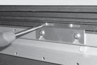 While holding the Tailgate Extrusion in place, use a #8 x 3/4" self tapping screw and power screw gun to secure the