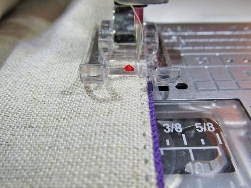 5. Hand stitch the button over the center seam. We stitched our button in place with two vertical lines of stitching to echo the topstitching down the center of the bag.