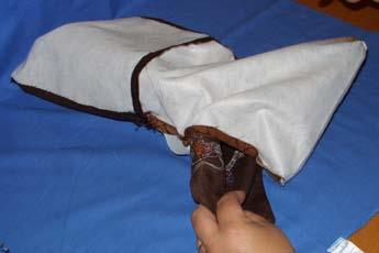 Center flap between side seams of bag body, line up raw edges and pin. Baste in place. Turn body lining right side out.