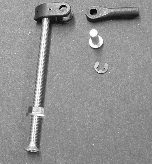 Insert the pushrod coupler into the servo mount. Slide the pivot pin into the servo mount and through the pushrod coupler. 4.
