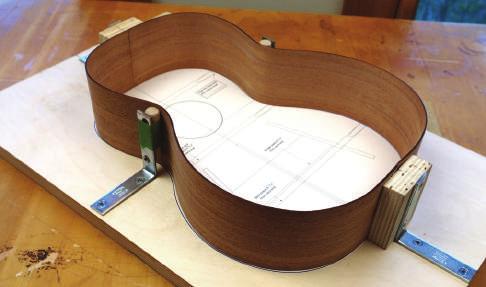 Assemble the body Place the bent sides into the body mold, with their ends butted together at the center. Now you can see the body of your ukulele taking shape!