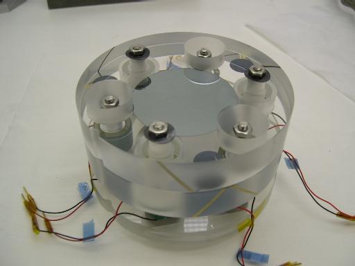 the reflective coating applied in the central ~50 mm There are three piezo-electric transducers supporting the bottom plate