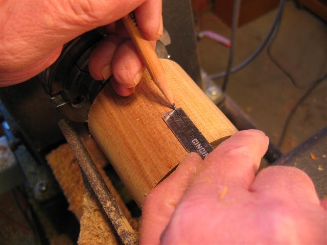 Form a tenon/spigot on each end sized to fit a four jaw chuck with a parting tool or beading/parting tool.