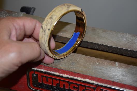 13) Place a piece of tape over the center of the brass metal core in a few places as