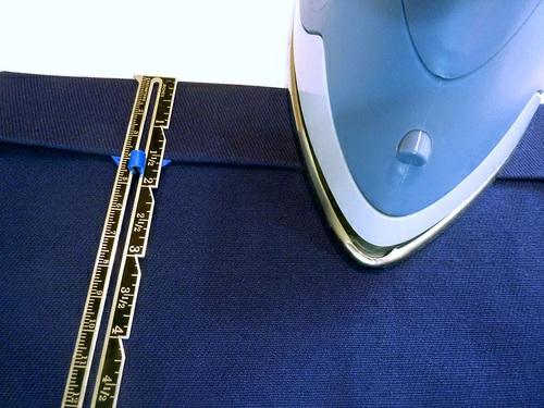 Fold in an additional ¼" and press again. Pin in place. 2. Make a 2" hem along top edge of the bib.