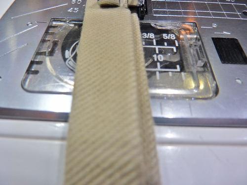 Pin one tie in place at the bottom corner of the armhole on each side, aligning the top edge of the