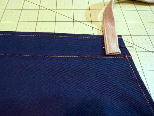 9. Re-thread the machine with the contrasting thread in the top and thread to match the apron top panel in the
