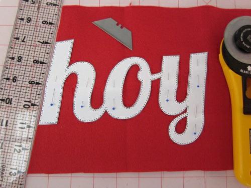 Place the fabric for the letters (red wool felt in our sample) right side up and flat on your work surface.