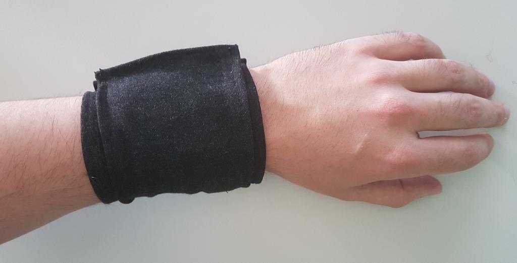 The vibration actuators are placed facing the fabric, thus not seen in the picture. Figure 3: Tactile wristband worn.