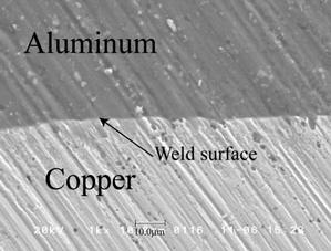 -SEM photograph of cross section of welded aluminum alloy plate specimens. Figure 11. -SEM photograph of cross section of welded aluminum and copper plate specimens.
