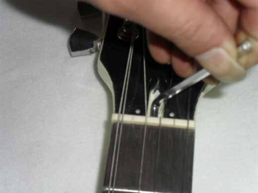 time do not be tempted to over-tighten the truss rod. Sighting along the neck should show a very slight concave tendency which is called relief and too straight a neck may lead to fret buzzing.