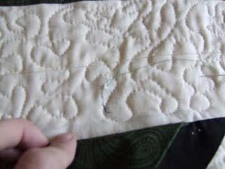 After quilting, I tacked the top prairie point down by lifting the point