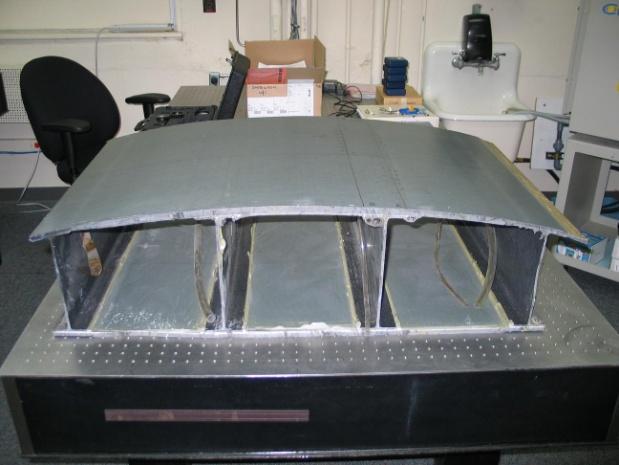 The wing section consists of a curved top skin layer, a flat bottom surface and four spars connecting the top and bottom surfaces.