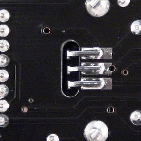 Insert as far down as possible, solder one pin, adjust the verticality, then solder the two other pins.