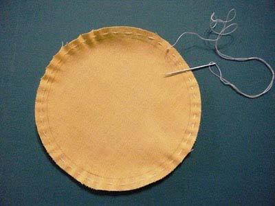 Thread a needle and hand baste around the circle as if you were making a yo-yo. Do not clip the thread.