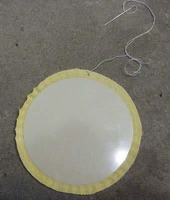 Place the template on the fabric circle (matching the drawn line) and pull the thread to gather the fabric.