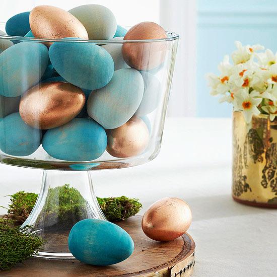 Use blown-out eggs to add a delicate touch to the centerpiece and a vintage container to house the contents. Center ribbon on craft wire and carefully feed through the egg.
