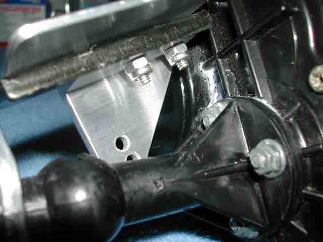 The lower shock mount and ESC plate both get attached to the short axle tube together. The ESC plate mounts on top of the axle tube brace, the lower shock mount installs below the axle tube brace.