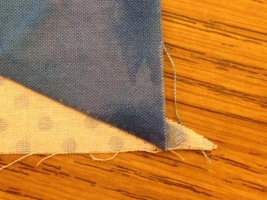 A scant ¼ of the wing should show (circled in diagram). 4. Sew and press seam toward the dark. Wrong: Corners are perfectly matched, but the unit will not square up correctly. Correct: 5.