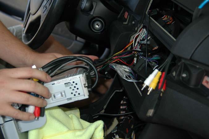 Now put a towel on your console to protect against scratches and carefully plug in the harness.